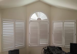 the half circle plantation shutter enhances the look of this work space